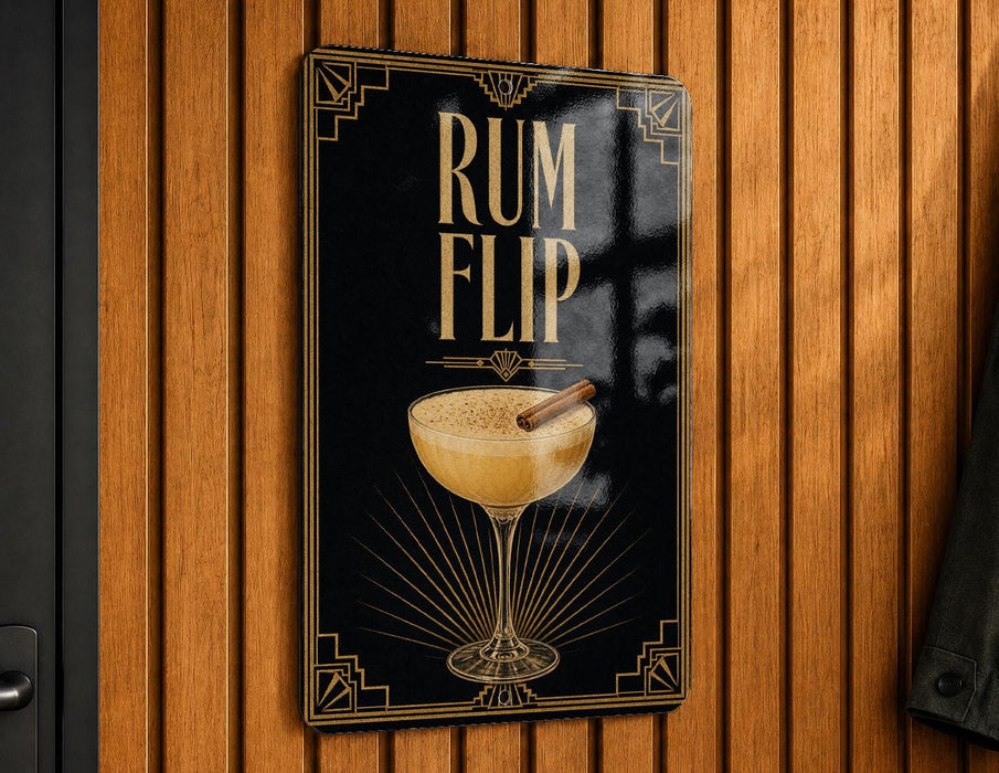 A sign with the text "RUM FLIP" and an illustration of a cocktail glass with a cinnamon stick.