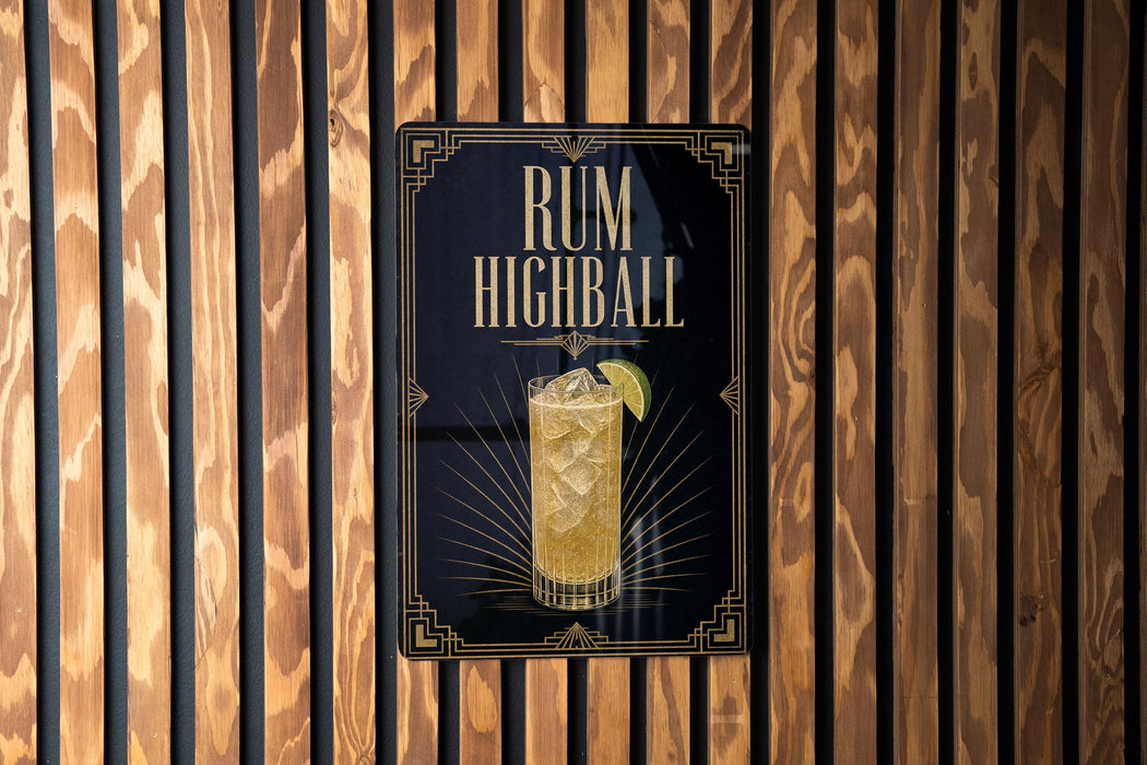 A sign for a rum highball cocktail is displayed on a wooden wall.