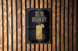 A sign for a rum highball cocktail is displayed on a wooden wall.