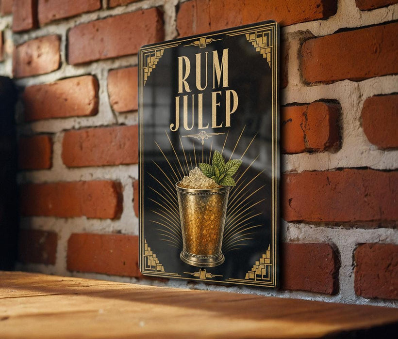 A framed poster of a rum julep cocktail is displayed on a brick wall.