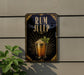 a sign for a rum julep cocktail, with a glass of rum and a green leaf garnish displayed on the sign.