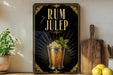 a decorative sign with the text "RUM JULEP" and an illustration of a cocktail glass with a lime garnish.