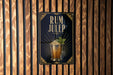 A sign for "RUM JULEP" is displayed on a wooden wall, featuring an illustration of a cocktail glass with a garnish.