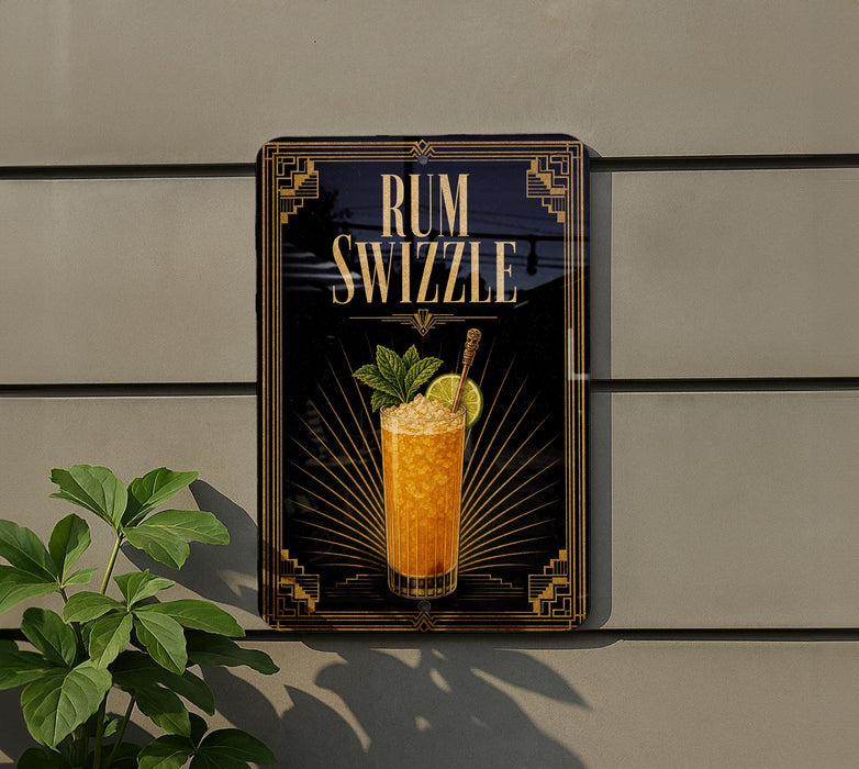 A sign for a rum swizzler cocktail is displayed on a wall, with a plant visible to the left.