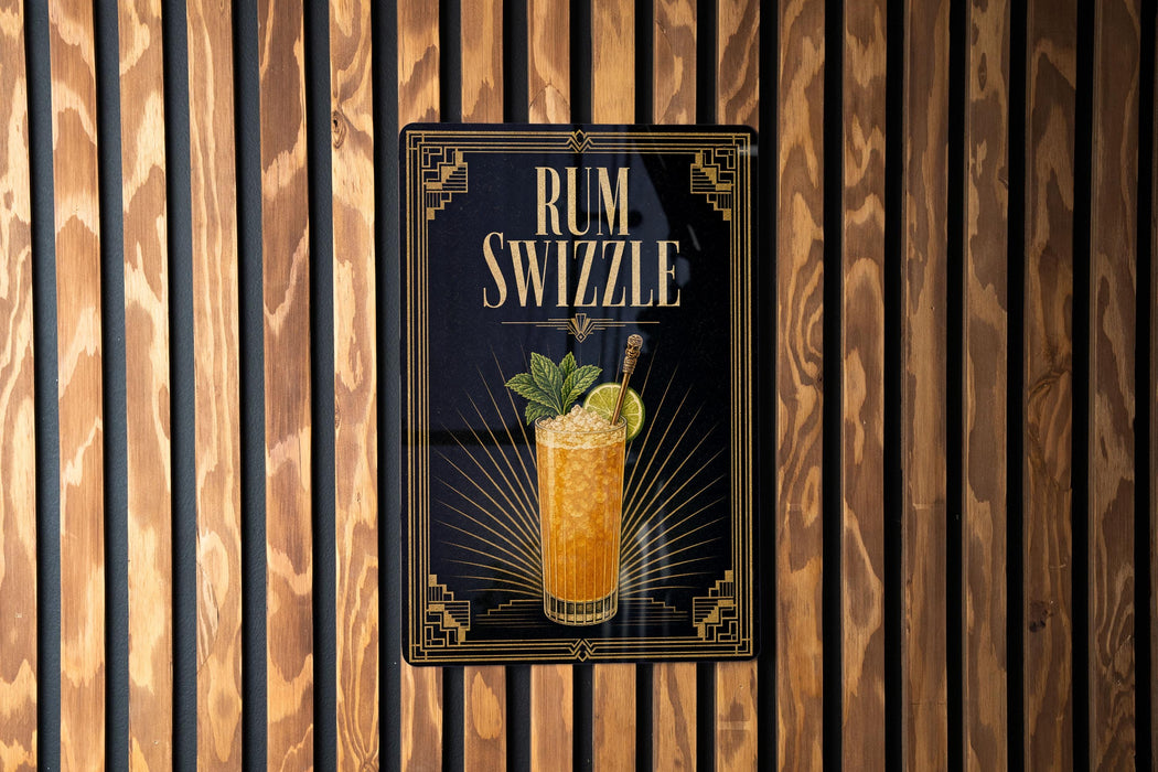 A framed poster of a rum swizzler is displayed on a wooden wall.