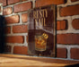 a sign with the text "RUSTY NAIL" and an illustration of a cocktail glass with a cocktail garnish.