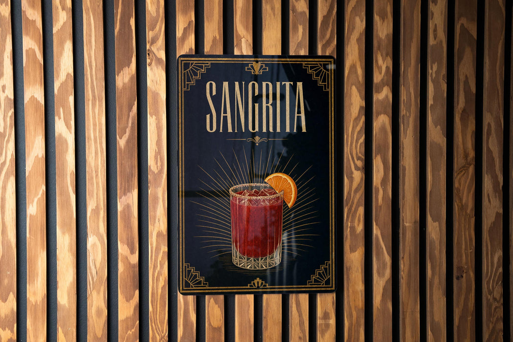 A sign for "Sangrita" cocktail is displayed on a wooden wall.