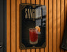 A sign for a Sangrita cocktail is displayed on a wooden wall.