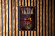 A poster with the word "SAZERAC" prominently displayed, featuring an illustration of a glass of red wine with a lemon peel.