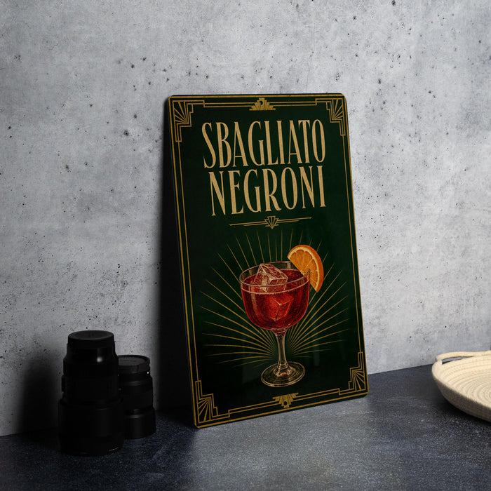 A framed poster or sign advertising "SBAGLIATO NEGRONI", featuring an illustration of a glass of Negroni with an orange slice.