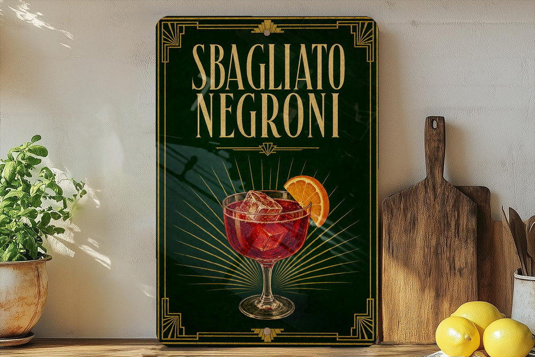 a poster or sign with the text "SBAGLIATO NEGRONI" and an illustration of a glass of Negroni, a type of Italian cocktail. The poster is displayed on a wall, and there are some kitchen utensils, such as a knife and a wooden cutting board, as well as some fruits, such as lemons, in the foreground.