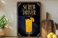 a decorative sign with the text "SCROW DRIVER" and an illustration of a glass of orange juice with a lemon slice.