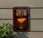 A sign for a bar called "Sidecar" with an illustration of a cocktail on it, mounted on a wall.