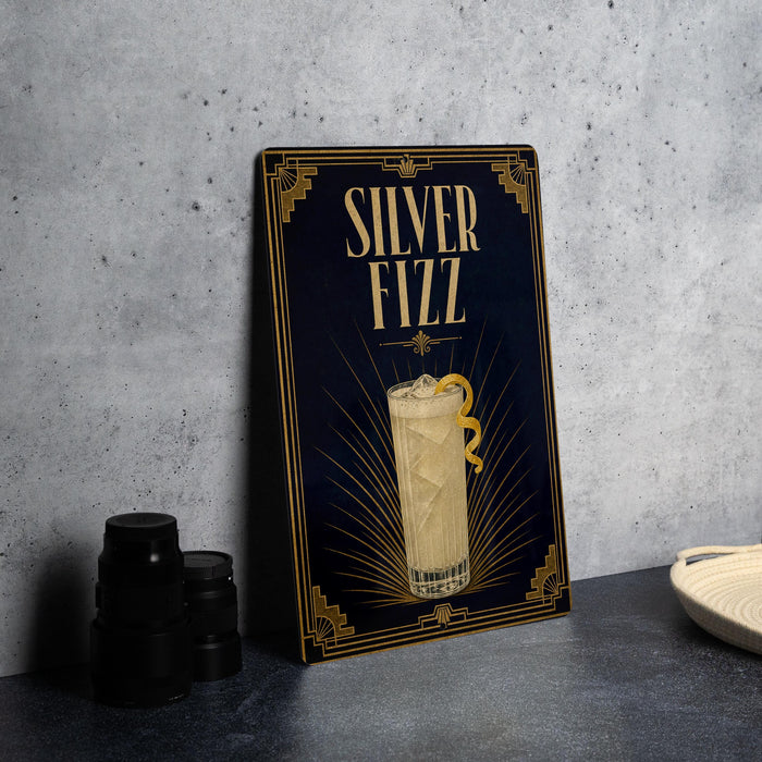 a framed advertisement for a "Silver Fizz" cocktail, with a glass illustration and decorative elements.
