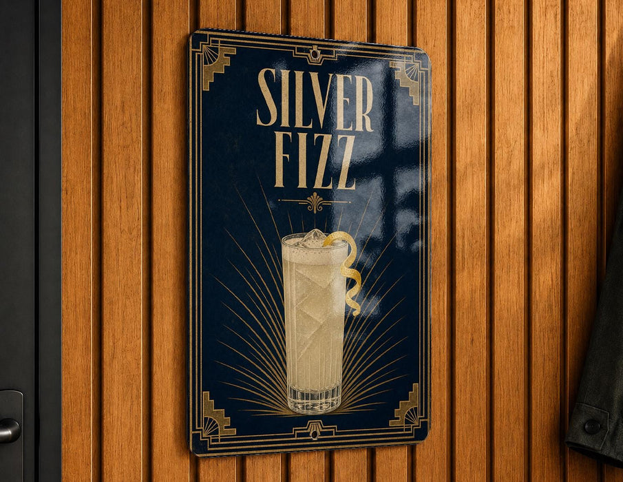 A sign for "Silver Fizz" cocktail, featuring an illustration of a tall glass filled with a yellow drink and a lemon twist.