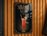 A sign for "Singapore Slinger" cocktail, featuring an illustration of a cocktail glass with a red drink, garnish, and straw.