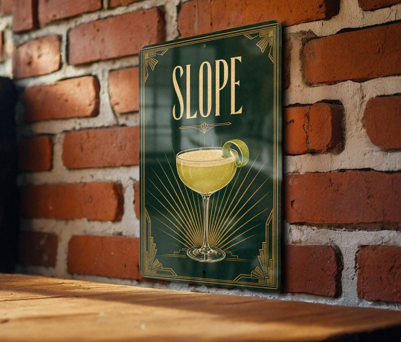 A green sign with a yellow cocktail glass on it, mounted on a brick wall.