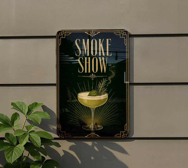a sign that reads "Smoke Show" with an illustration of a cocktail glass and a plant on it.