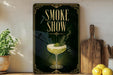 a framed poster with a stylized illustration of a cocktail glass and the text "SMOKE SHOW" prominently displayed.