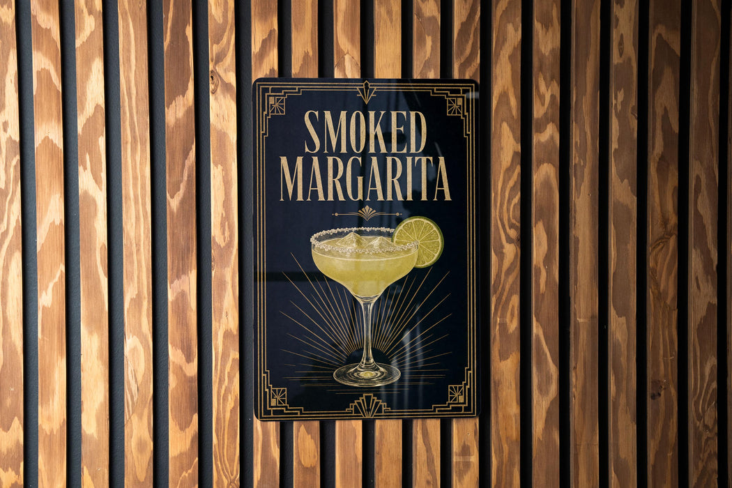 A sign for a "Smoked Margarita" cocktail is displayed on a wooden wall.