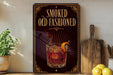 a sign that reads "Smoked Old Fashioned" with an illustration of a glass of Old Fashioned and a lemon slice.
