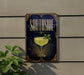A decorative sign for a cocktail called "Southside" is displayed on a wall, featuring a glass of yellow liquid and a green leaf garnish.