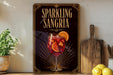 A framed poster advertising "Sparkling Sangria" is displayed on a wall, with a glass of red wine and orange slices in the center.