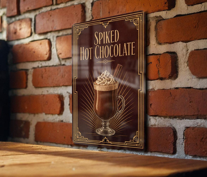 A framed poster of a hot chocolate drink is displayed on a brick wall, with the text "Spiked Hot Chocolate" prominently featured.