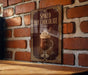 A framed poster of a hot chocolate drink is displayed on a brick wall, with the text "Spiked Hot Chocolate" prominently featured.