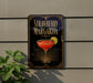 A sign for a strawberry margarita cocktail is displayed on a wall, featuring a glass of the drink with a strawberry garnish and a lime wedge.