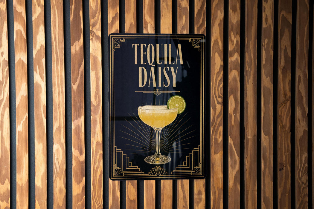 A sign for "Tequila Daisy" cocktail is displayed on a wooden wall.