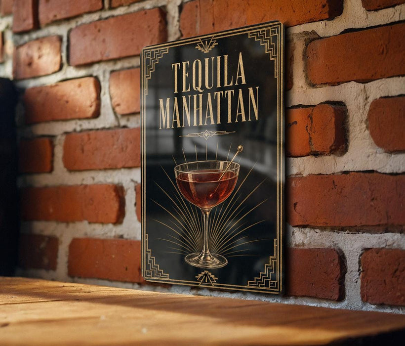 A decorative sign on a brick wall that reads "TEQUILA MANHATTAN" with an illustration of a glass of tequila.
