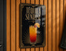 A sign for "Tequila Sunrise" is displayed on a wooden wall.