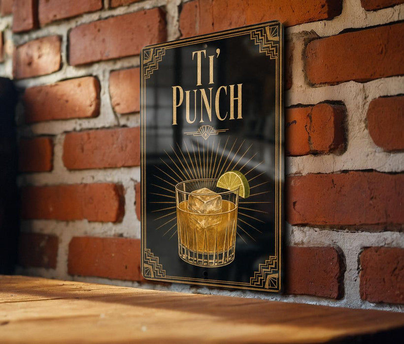 A sign with the text "T' PUNCH" and an illustration of a cocktail glass with a lime slice, mounted on a brick wall.