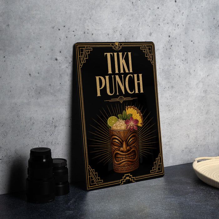 A framed poster or sign for "Tiki Punch" is displayed on a table, featuring an illustration of a tiki mug with tropical fruits and a tiki mask.