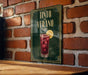 a sign for a drink called "Tinto de Verano" with a glass illustration and a lemon slice.