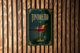 A sign for "Tintoretto" cocktail is displayed on a wooden wall.
