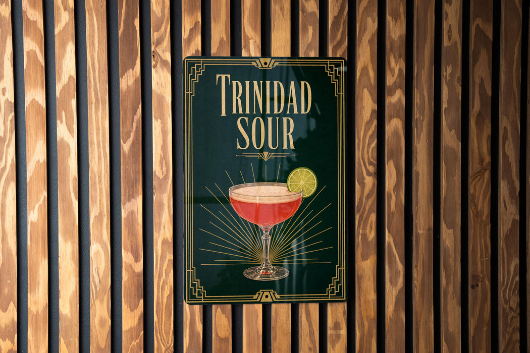 A sign for "Trinidad Sour" cocktail is displayed on a wooden wall.