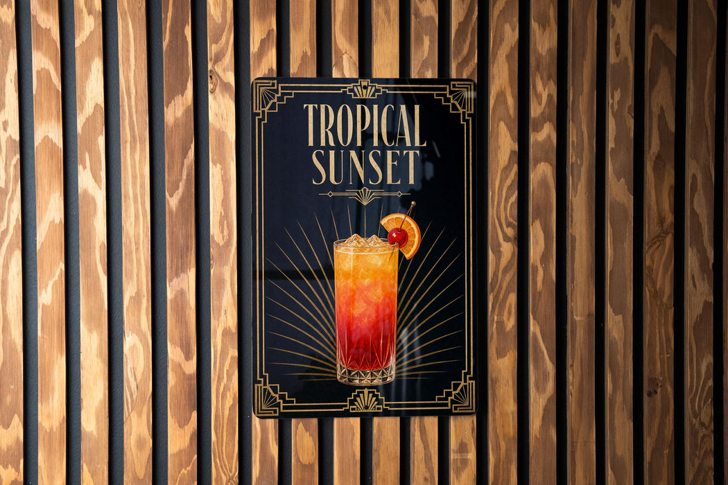 A sign for a tropical sunset cocktail is displayed on a wooden wall.