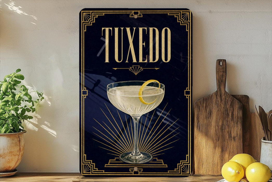 A framed poster of a cocktail glass with a lemon on top, placed on a shelf next to a wooden cutting board and some lemons.