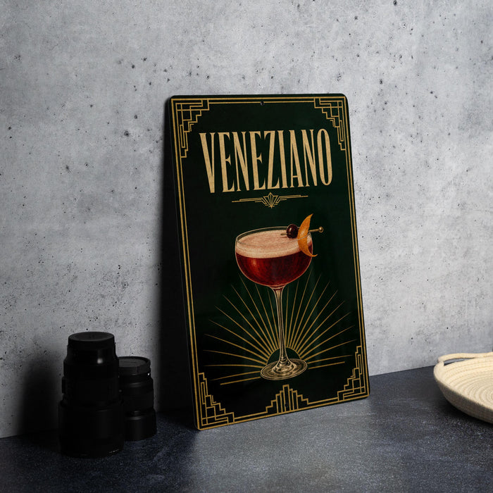 a framed poster of a Venetian cocktail, with a glass of the drink and a garnish on the poster.