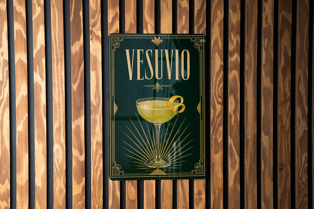 A poster with the word "VESUVO" displayed prominently, featuring a glass of yellow liquid and a lemon slice.
