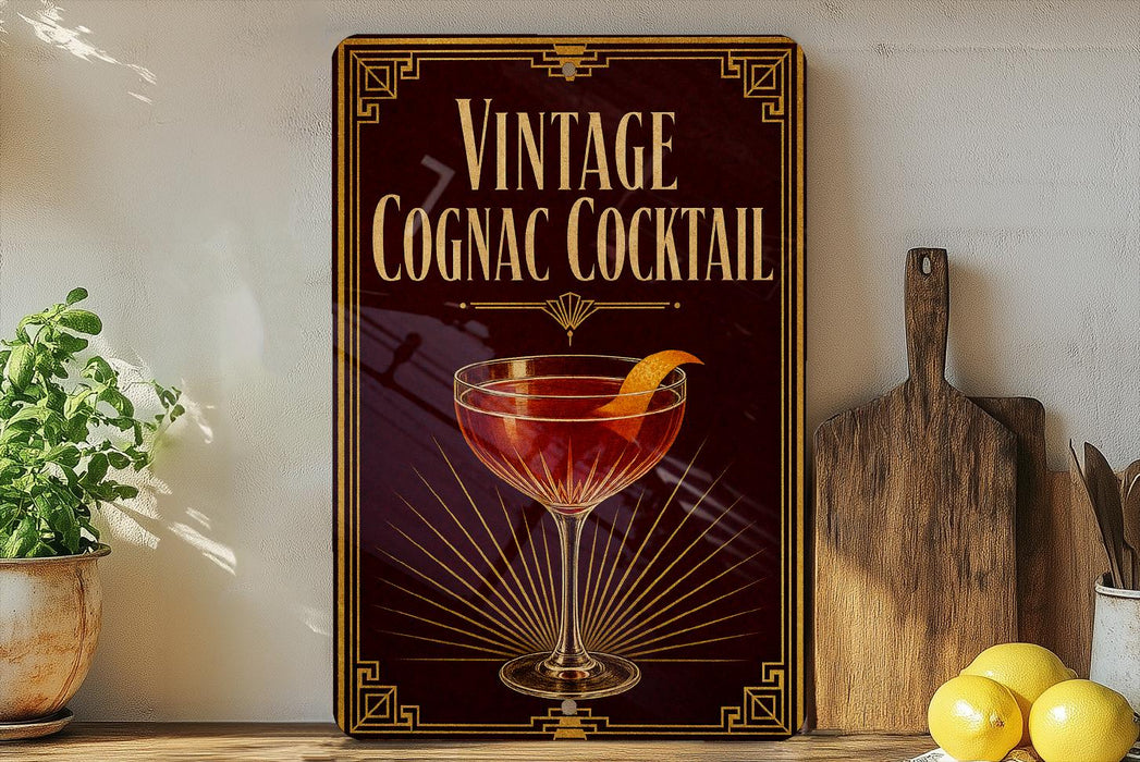 A vintage-style sign advertising a cognac cocktail, featuring an illustration of a glass filled with a red-colored drink and an orange peel.