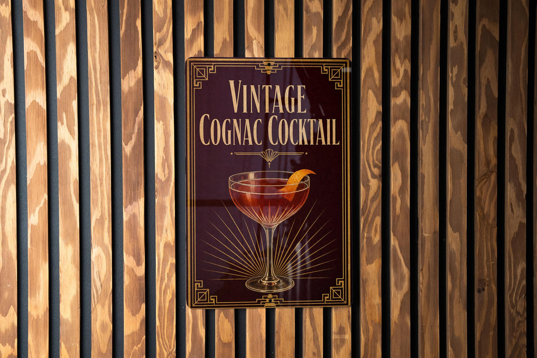 A vintage Cognac cocktail sign is displayed on a wooden wall.