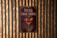 A vintage Cognac cocktail sign is displayed on a wooden wall.
