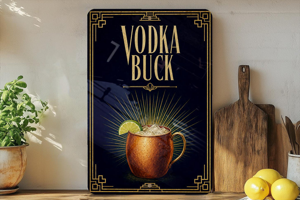 a decorative sign with the text "VODKA BUCK" and an illustration of a copper mug with a lime slice. The sign is displayed on a shelf, with a potted plant, a wooden cutting board, and some lemons nearby.
