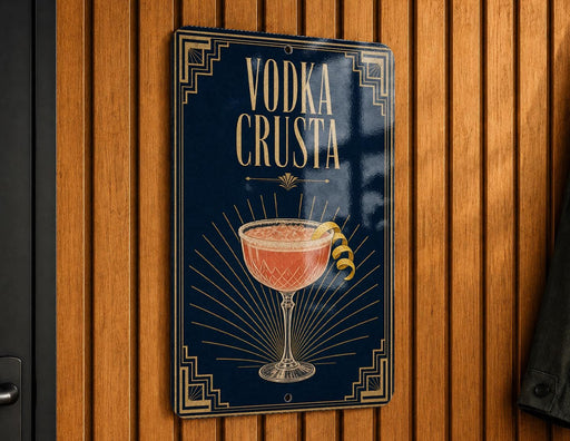 A sign with the text "VODKA CRUSTA" and an illustration of a cocktail glass with a lemon twist.
