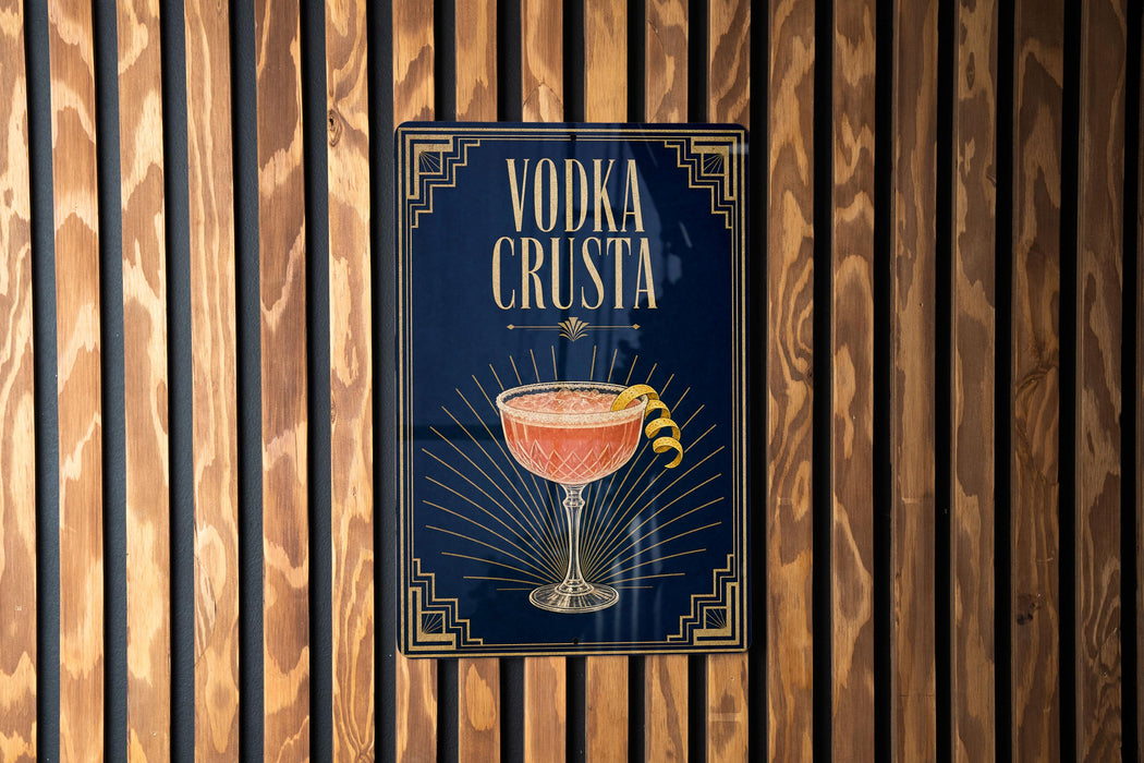 a sign with the text "VODKA CRUSTA" and an illustration of a cocktail glass with a lemon twist.
