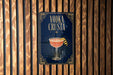 a sign with the text "VODKA CRUSTA" and an illustration of a cocktail glass with a lemon twist.