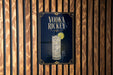 A sign for vodka richey is displayed on a wooden wall.